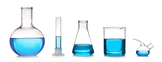 Blue hydroponic nutrient solution measured across beakers, flasks and a cylinder representing mixing hydroponic  nutrients